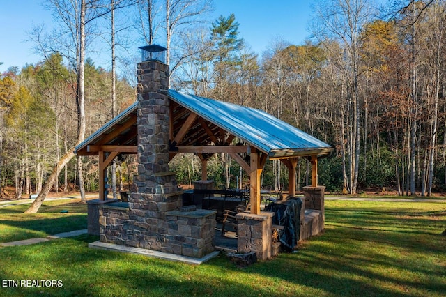 view of property's community featuring a yard, a gazebo, and a view of trees