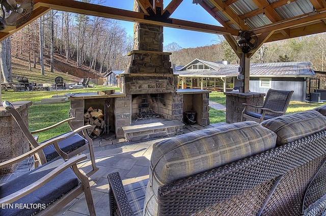 view of patio / terrace with an outdoor stone fireplace