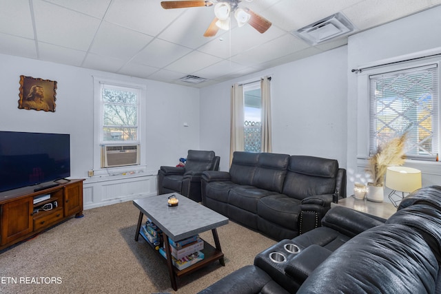 carpeted living room featuring visible vents, cooling unit, ceiling fan, and a paneled ceiling