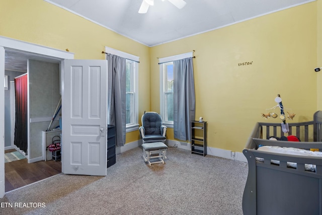 bedroom with carpet floors, ornamental molding, baseboards, and ceiling fan