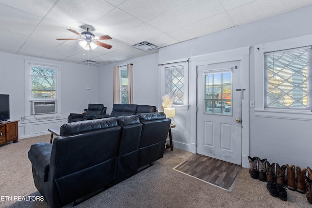 living room with cooling unit, carpet flooring, a wealth of natural light, and ceiling fan