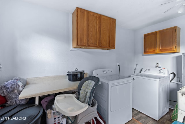 laundry area featuring cabinets, dark wood-type flooring, and washer and dryer