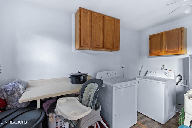 laundry room with dark wood finished floors, cabinet space, and washer and dryer