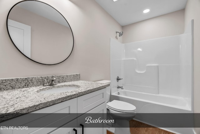 full bathroom featuring wood-type flooring,  shower combination, vanity, and toilet