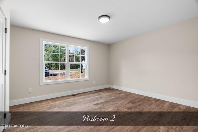 empty room with light hardwood / wood-style flooring