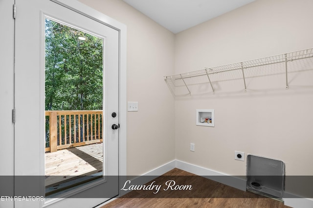 washroom featuring washer hookup, dark hardwood / wood-style floors, and electric dryer hookup