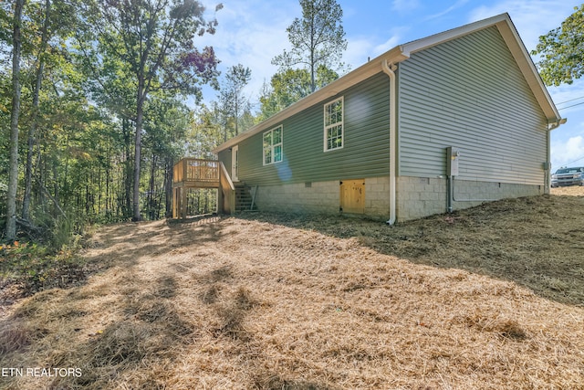 view of property exterior featuring a deck