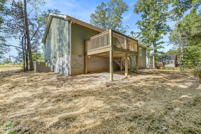 back of house featuring a deck