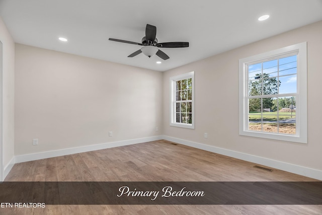 empty room with light hardwood / wood-style flooring and ceiling fan