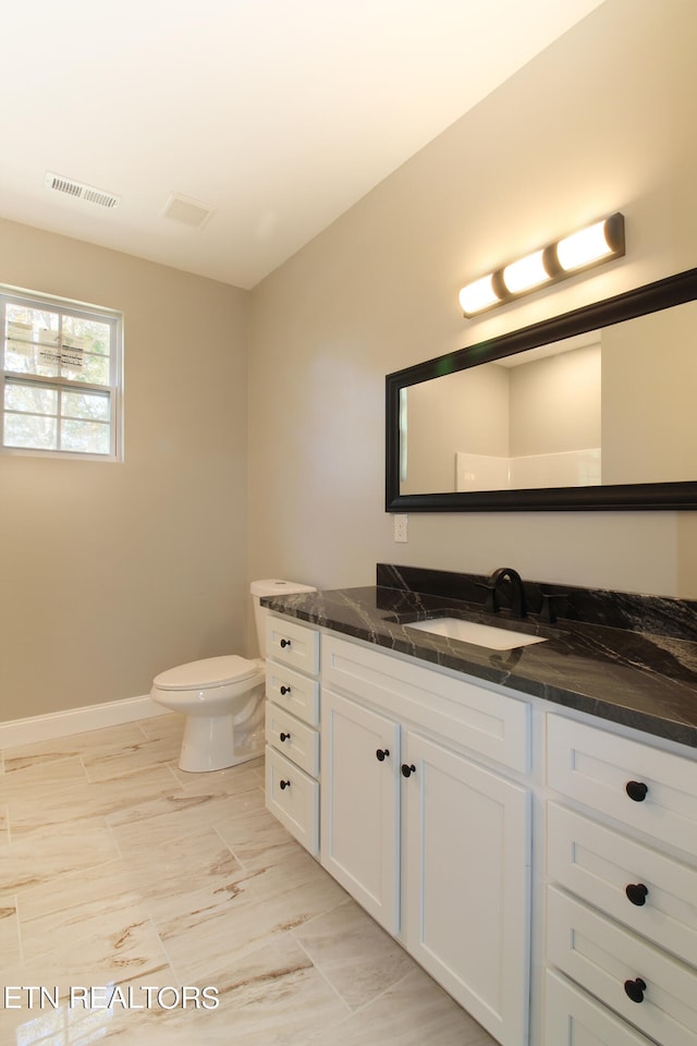 bathroom featuring vanity and toilet