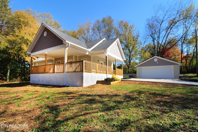 view of home's exterior with a lawn, an outbuilding, a porch, and a garage