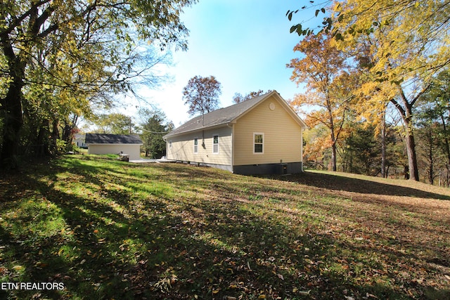 view of side of property with a lawn