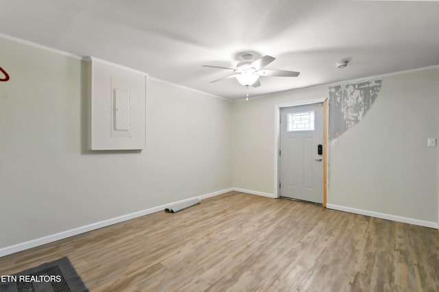 foyer entrance featuring wood-type flooring, ornamental molding, and ceiling fan