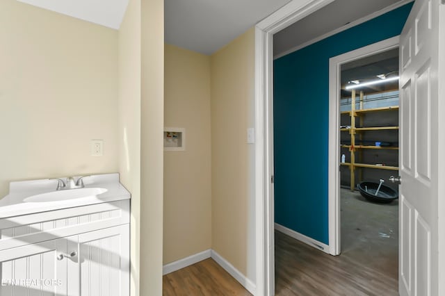 clothes washing area with hookup for a washing machine, dark wood-type flooring, and sink