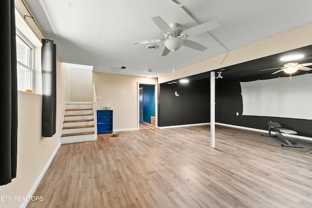 basement with light wood-type flooring and ceiling fan