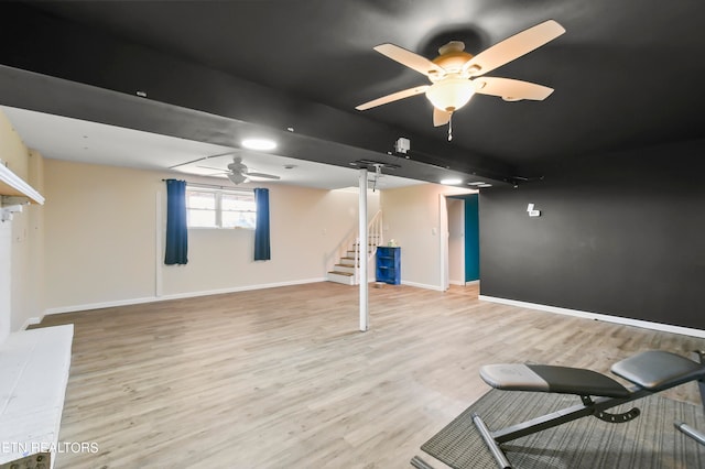 basement featuring ceiling fan and light hardwood / wood-style flooring