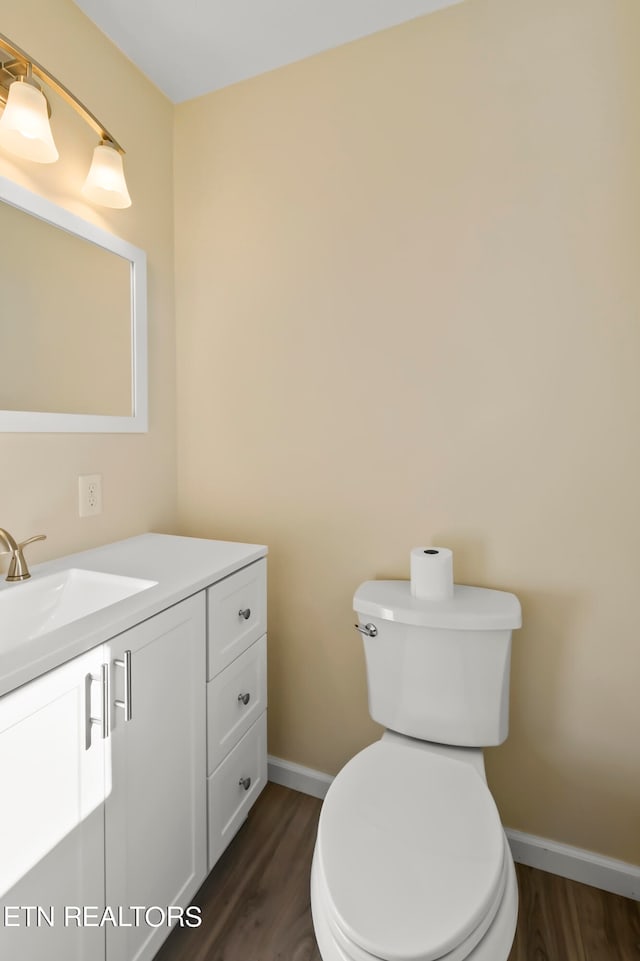 bathroom featuring hardwood / wood-style floors, vanity, and toilet