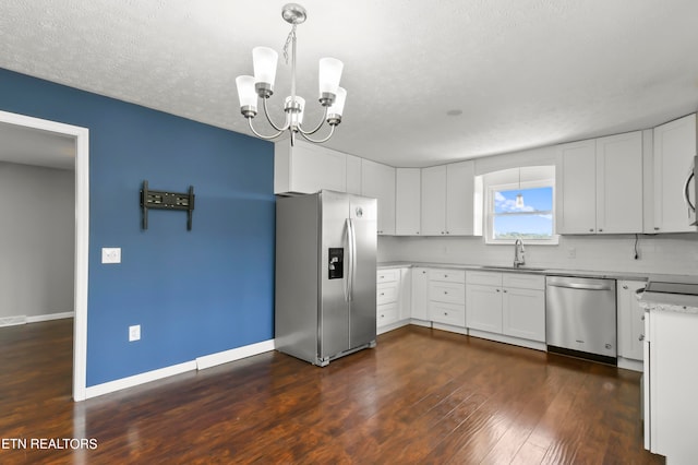 kitchen featuring pendant lighting, white cabinets, appliances with stainless steel finishes, and dark hardwood / wood-style flooring