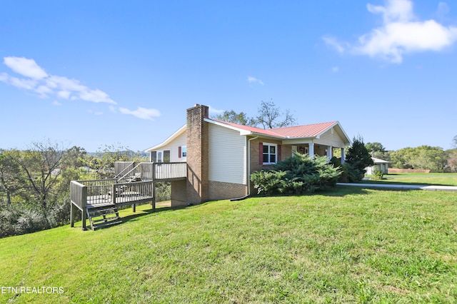 view of property exterior featuring a yard and a wooden deck