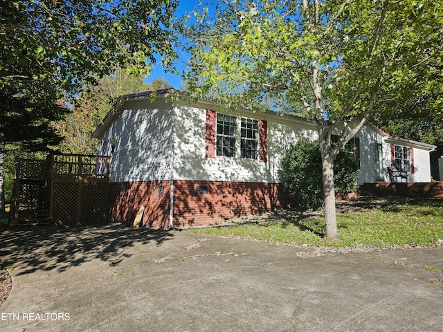 view of property exterior with a deck