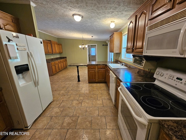 kitchen featuring hanging light fixtures, ornamental molding, a notable chandelier, kitchen peninsula, and white appliances