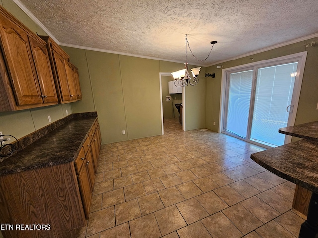 kitchen with crown molding, a chandelier, pendant lighting, and a textured ceiling