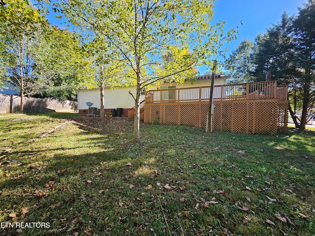 view of yard with a wooden deck and central AC unit