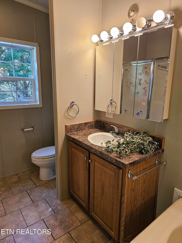 bathroom featuring vanity, crown molding, and toilet