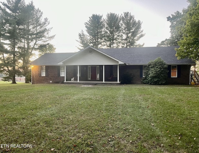 back of house with a lawn