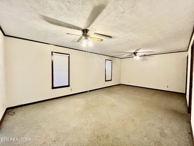 carpeted empty room featuring ceiling fan and a textured ceiling