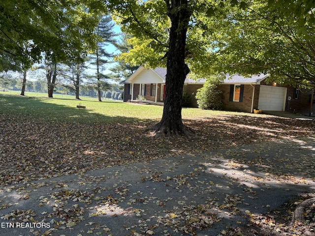 exterior space featuring a garage and a front yard