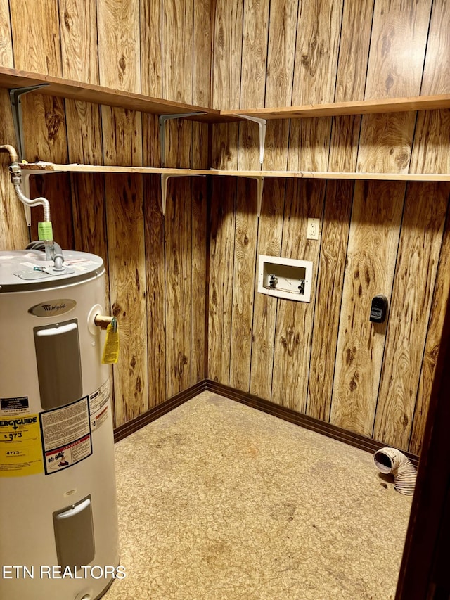 laundry area featuring wood walls, hookup for a washing machine, electric water heater, and carpet flooring