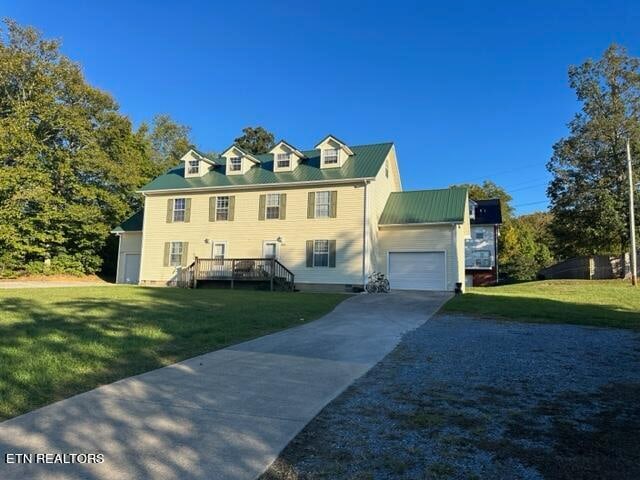 view of front of home featuring a garage and a front lawn