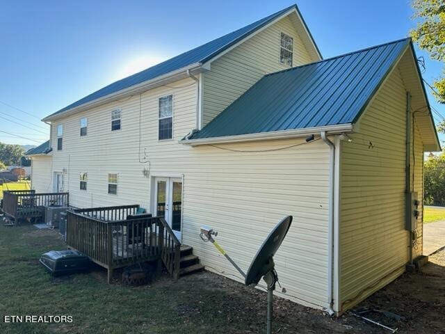 back of property featuring a deck