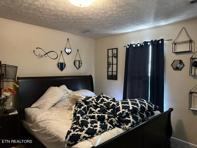 bedroom featuring a textured ceiling