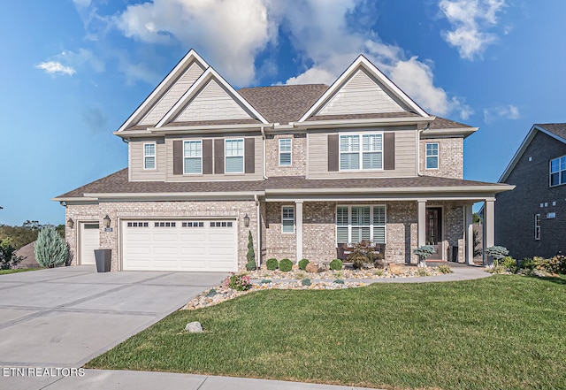 craftsman inspired home featuring a garage and a front yard