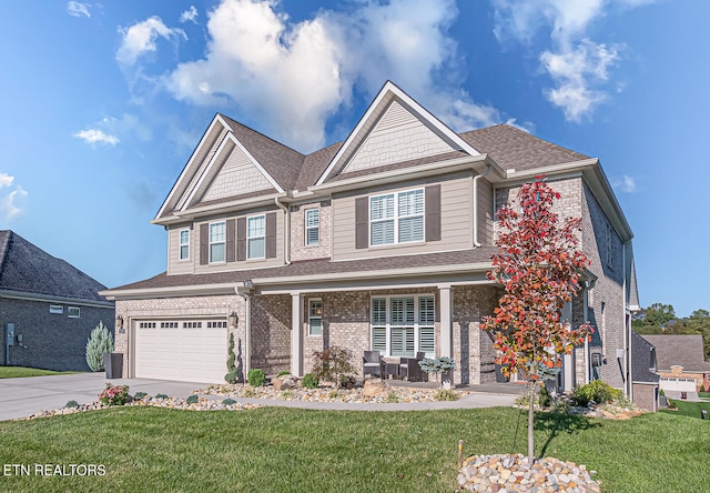 craftsman-style house featuring a garage and a front lawn