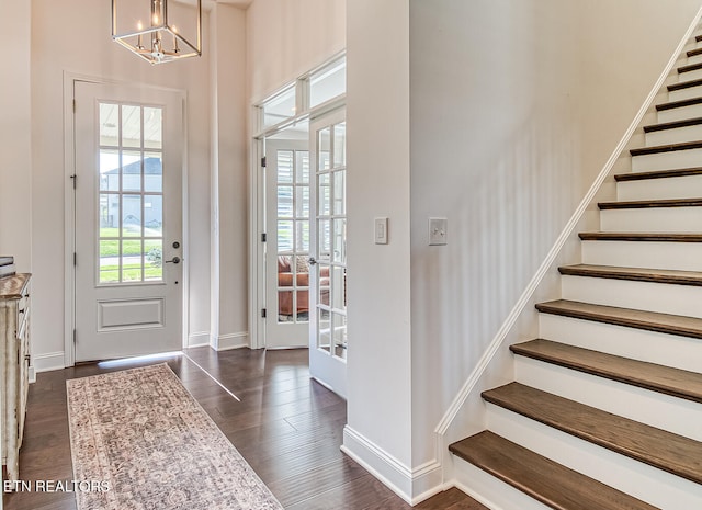 entryway featuring a notable chandelier and dark hardwood / wood-style floors