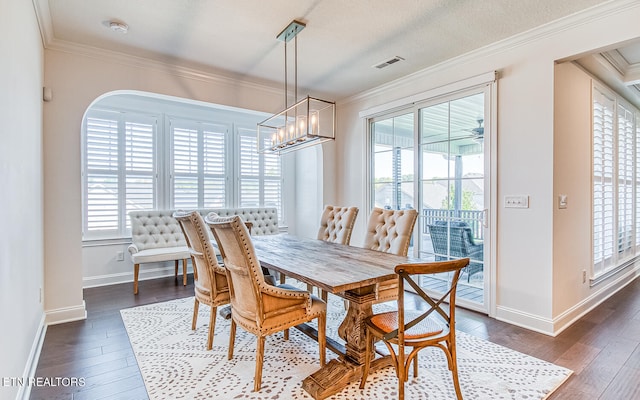 dining room featuring ornamental molding, plenty of natural light, and dark hardwood / wood-style floors