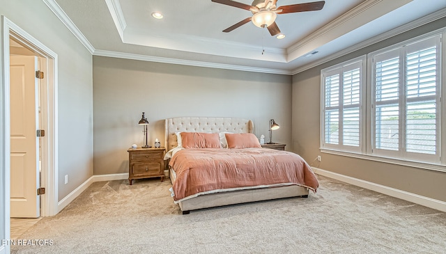 carpeted bedroom featuring a raised ceiling, crown molding, and ceiling fan