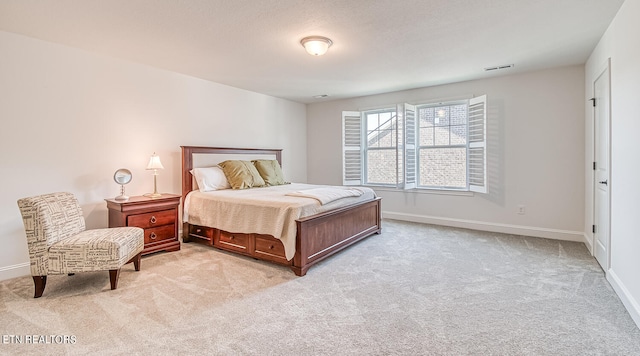 bedroom featuring light carpet