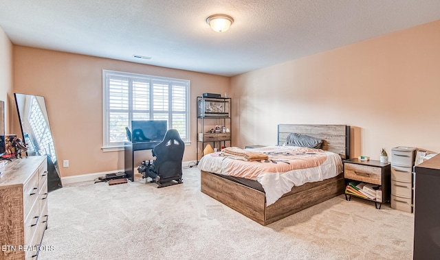 carpeted bedroom featuring a textured ceiling