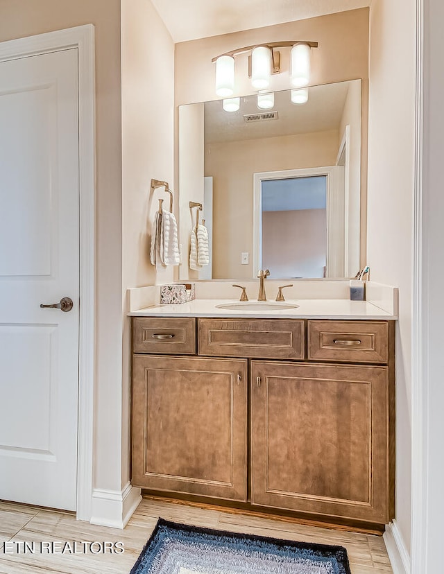 bathroom with hardwood / wood-style floors and vanity