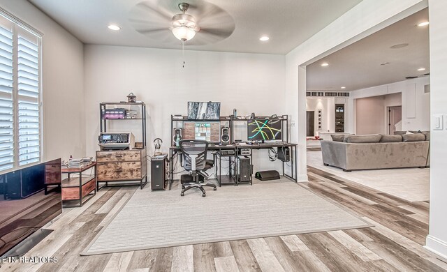 office area featuring light hardwood / wood-style floors, a wealth of natural light, and ceiling fan