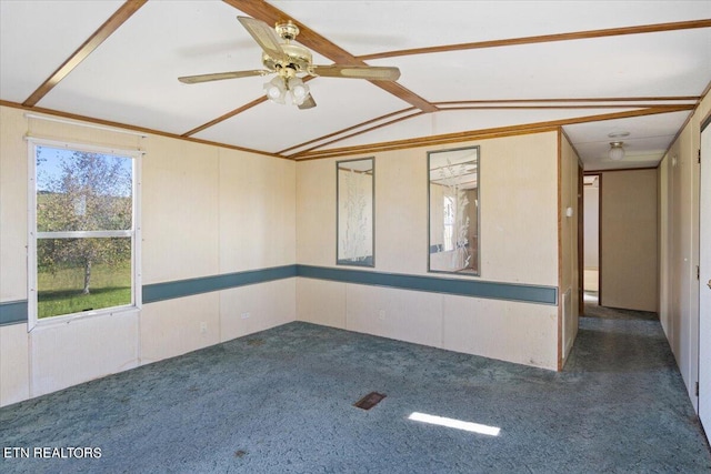 carpeted empty room featuring ceiling fan and vaulted ceiling