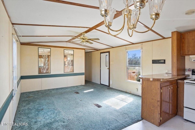 kitchen with ceiling fan, decorative light fixtures, electric range, light carpet, and vaulted ceiling