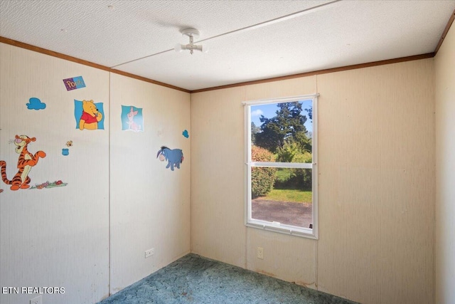 unfurnished room featuring ornamental molding and carpet