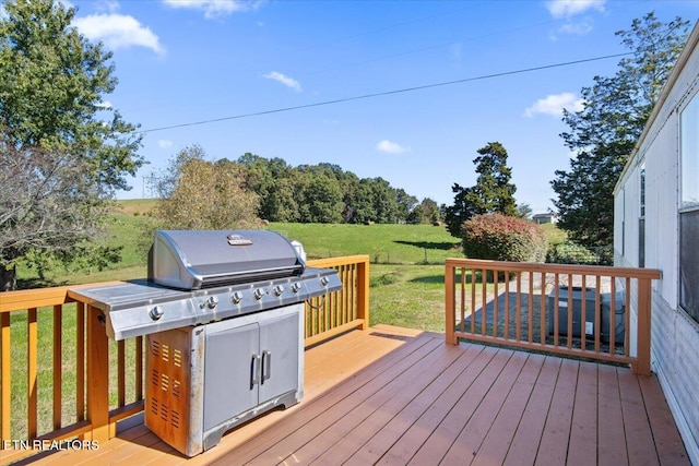 wooden terrace with a yard and grilling area