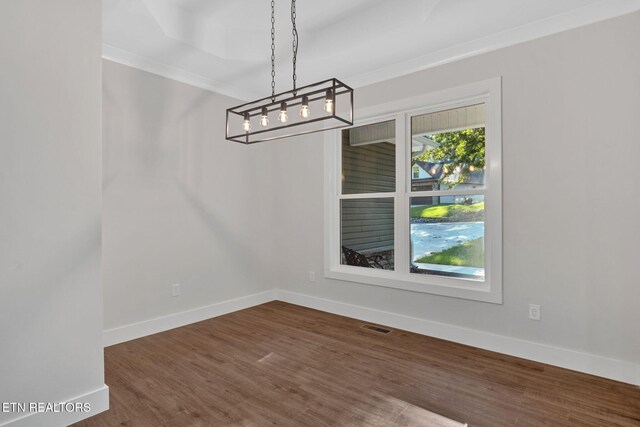 unfurnished dining area with crown molding and dark hardwood / wood-style flooring