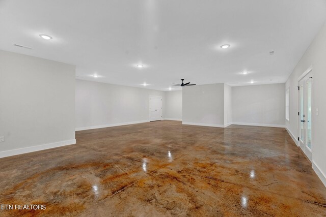 spare room with concrete flooring and ceiling fan